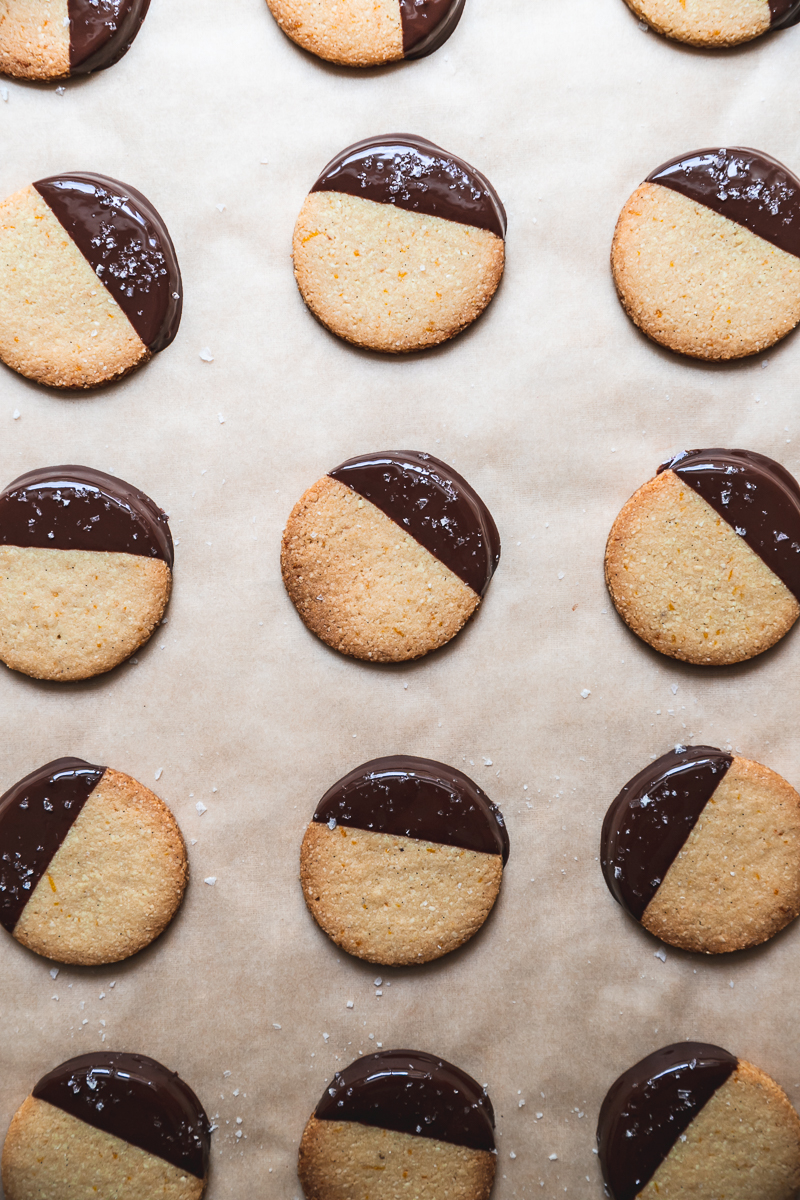orange and almond gluten free shortbread cookies dipped in dark chocolate and sprinkled with sea salt